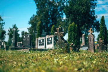 Old concrete christian cross tombstone on a graveyard...
