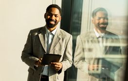 Business professional engages with a tablet while...