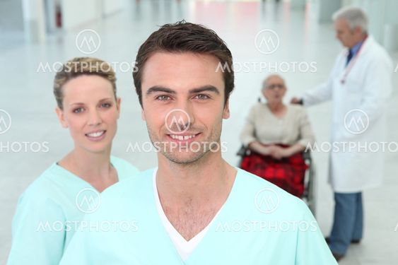 Hospital staff with elderly patient