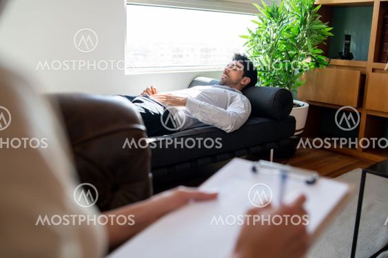 Psychologist talking with patient on therapy session.
