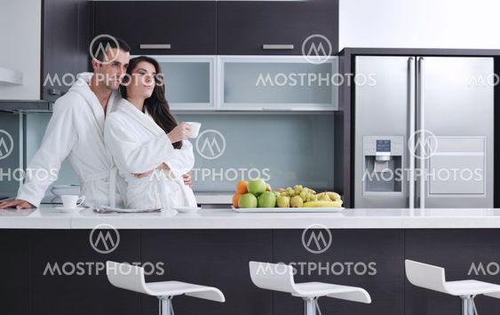 young couple have fun in modern kitchen