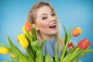 Pretty woman with red yellow tulips bunch