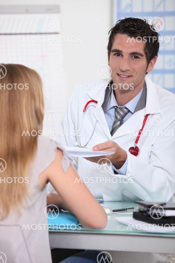 Male doctor with young patient