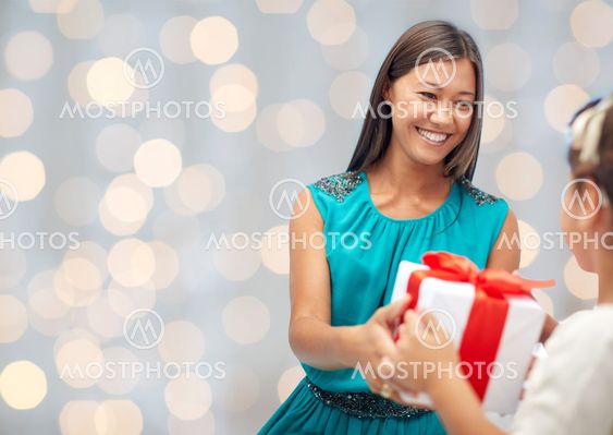happy mother giving birthday present to her child