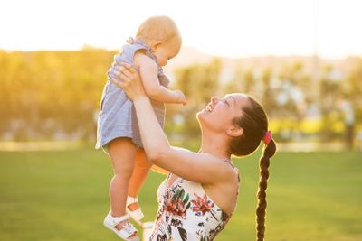Close-up Of A Mother Carrying Her Baby Daughter