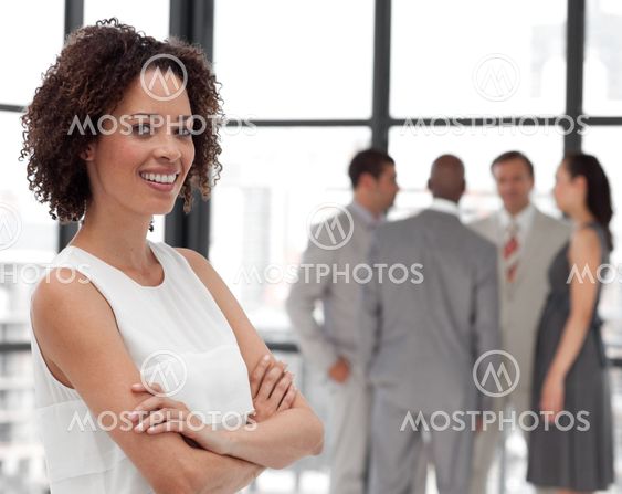Bright Businesswoman arms folded with his colleagues