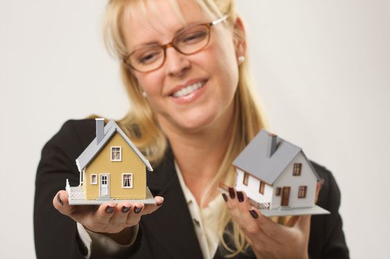 Woman Holding Two Houses