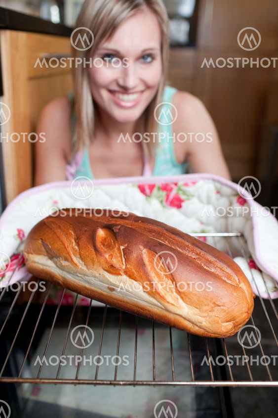 Happy woman baking bread