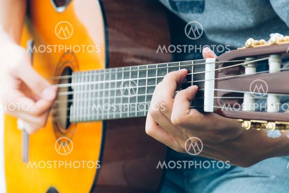 hand playing on guitar