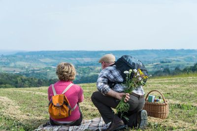 Senior couple sitting in the field