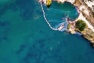 aerial shoot of a lake coast with sand mining