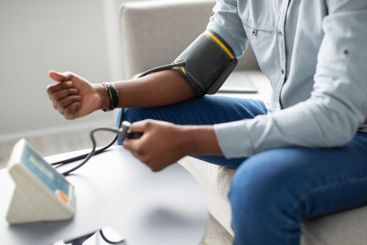 Unrecognizable African Guy Measuring Arterial Pressure...