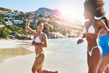 Holiday, friends and running in bikini by beach for fun...