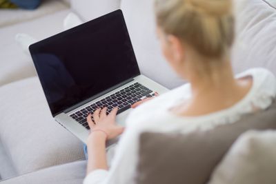 Young woman using laptop at home
