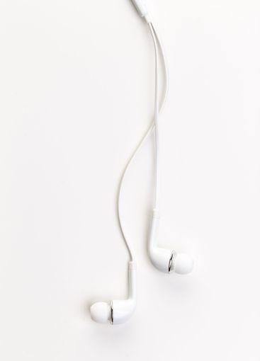 Pair of earphones close up on grey background