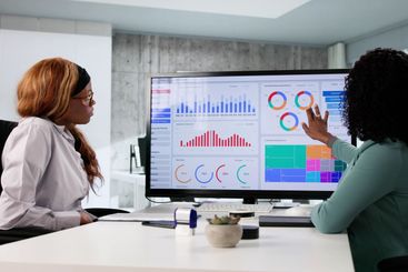 Young, female African analyst using touchscreen technology