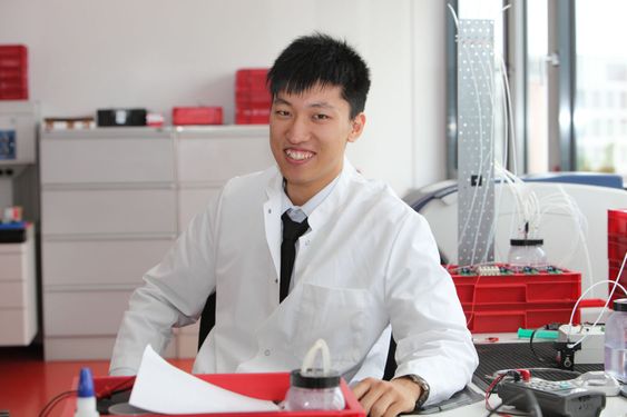 Smiling Asian laboratory technician