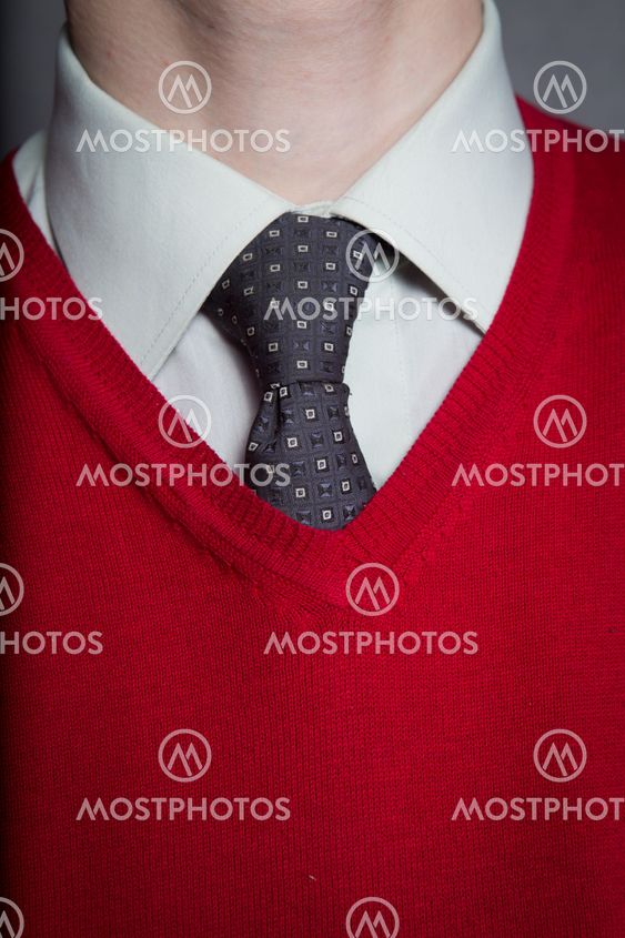 Man wearing white shirt, red sweater and necktie