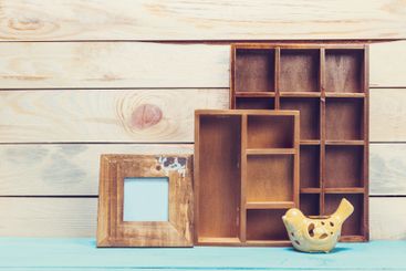 Cozy pastel wooden home decor objects on blue background