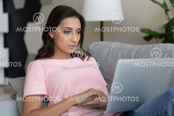 Close up confident Arabian woman using laptop, relaxing...