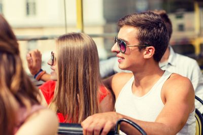 smiling couple traveling by tour bus