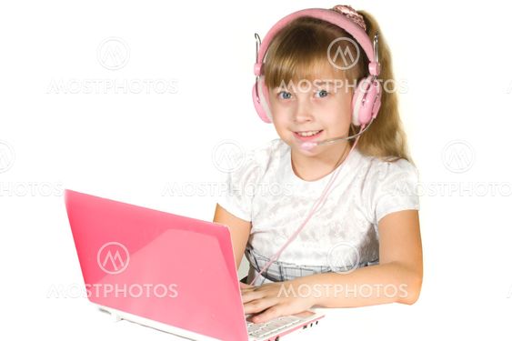 Beautiful little girl with headphones and a computer.