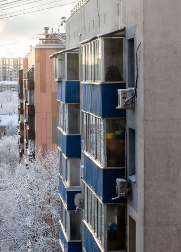 facades of multi-story houses in winter evening