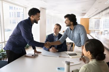 Happy successful multiethnic male business partners...