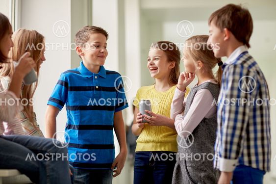 group of school kids with soda cans in corridor