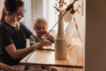 Woman working at home with her baby