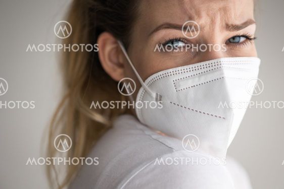 Young woman wearing a face mask during coronavirus and...