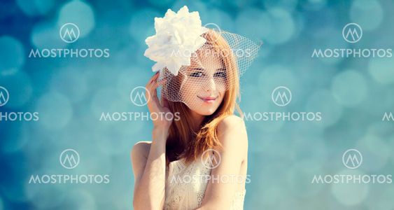 Young bride at blue sky background.