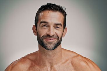 Smile, skincare and portrait of man in studio for...
