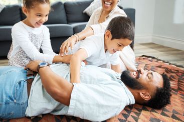Parents, children and happy in home with game, tickling...