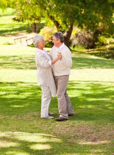 Senior couple dancing in the park