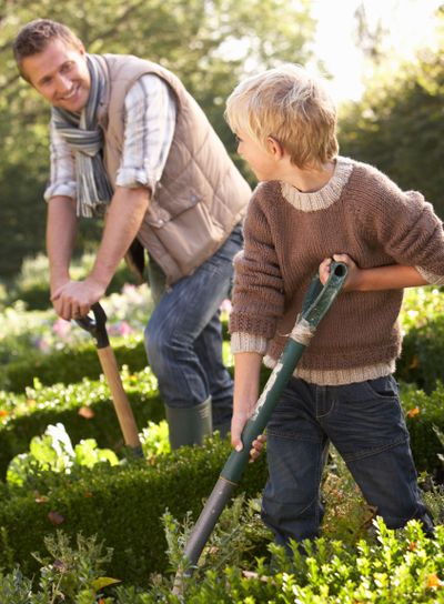 Young man with child working in garden