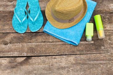 Bright summer essentials arranged on a wooden surface...