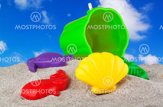 Child's bucket, spade and other toys on beach