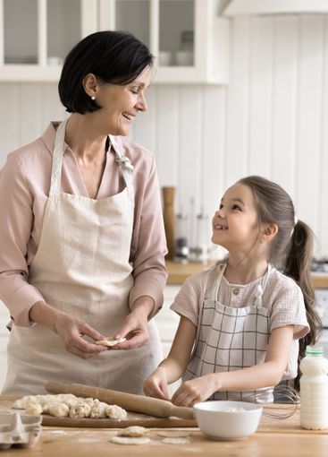Happy smiling old grandmother little granddaughter...