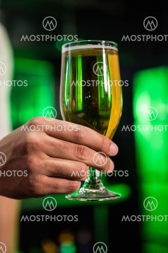Bartender serving a glass of beer