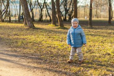 Happy baby child outdoor. Little toddler boy having fun...