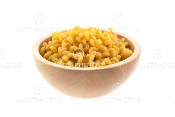 spiral pasta in a wood bowl