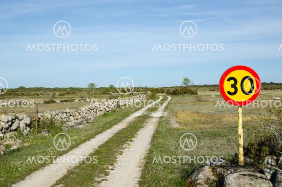 Speed limit sign at rural tracks in a plain grassland