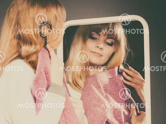 Pretty girl looking into mirror.