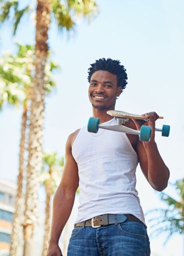 Portrait, man and skateboard in city for sport, travel...