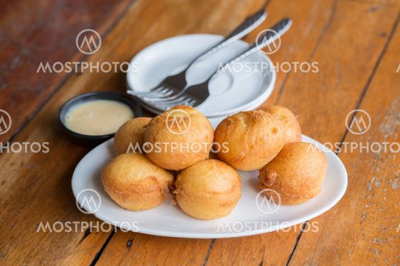 Delicious banana fritters serve with Sweetened condensed milk