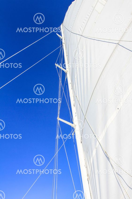 Looking at boat mast with rigging and blue sky