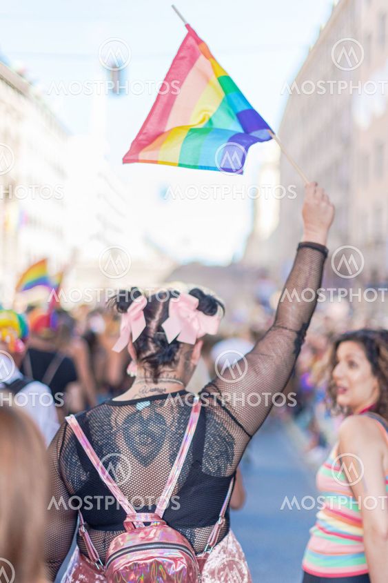 Back of a woman in black at the pride parade in Stockholm