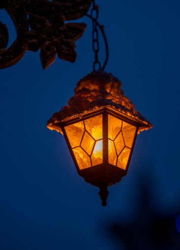 Hanging outdoor lamp at dusk.