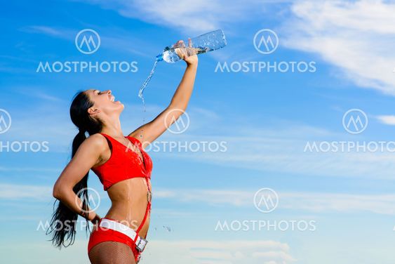 sport girl in red uniform with a bottle of water